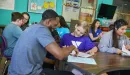 Thumbnail: ymca y club staff helps a young student with homework