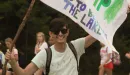 Thumbnail: young man with flag at campfire