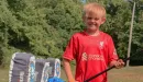 Thumbnail: young boy retrieving his arrows at the archery range