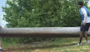 Thumbnail: two young men putting a canoe in the lake