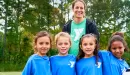 Thumbnail: ymca youth soccer participants smile with their volunteer coach
