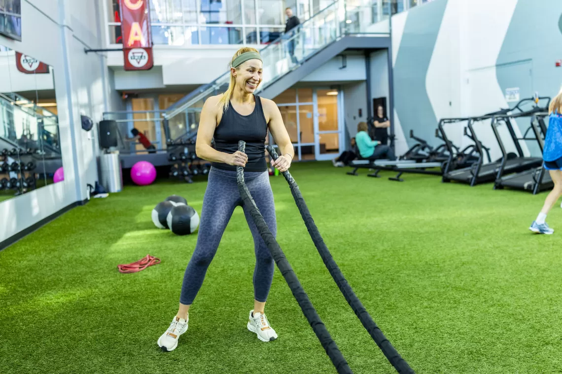 Woman Working Out Using Ropes in a YMCA Functional Fitness Studio During a Small Group Training Class