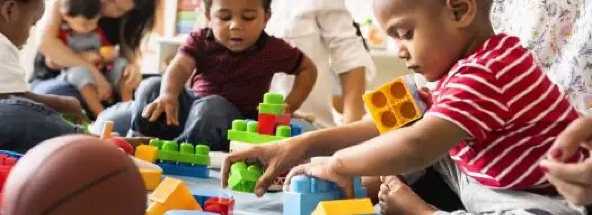 infants play with building blocks in a ymca early learning readiness program
