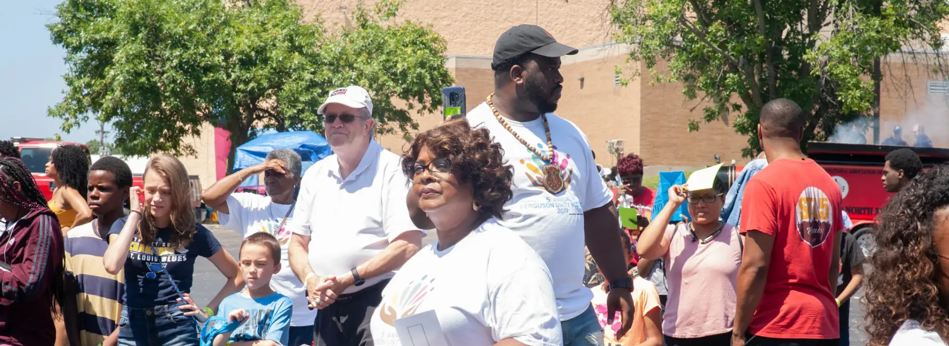 An image taken of the diverse group of men, women, and children taken at the YMCA's backpack give-away.