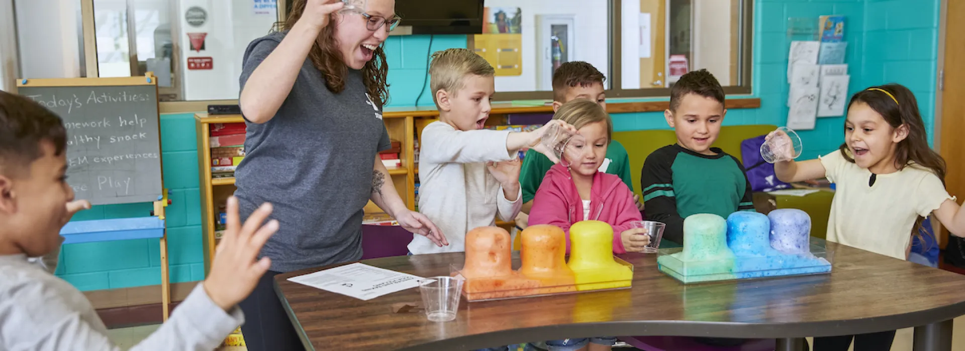 ymca y club staff doing a STEAM experiment with y club participants