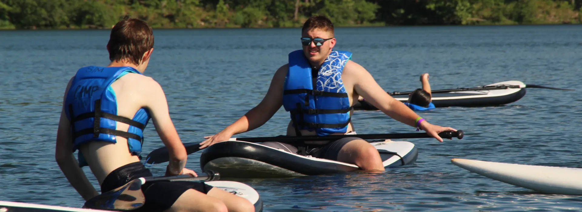 two young men on paddle boards