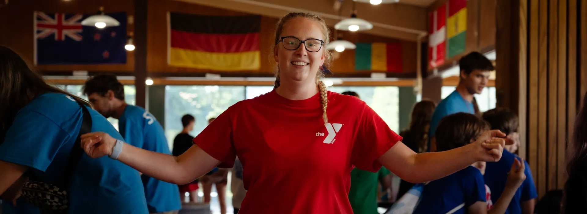 Happy staff member indoors with others