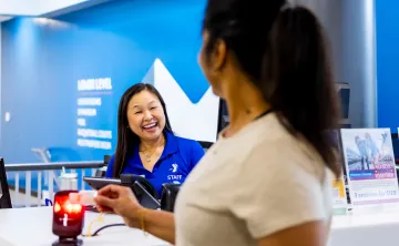 YMCA member checking in at the YMCA front desk being used as a blog image focused on gym anxiety